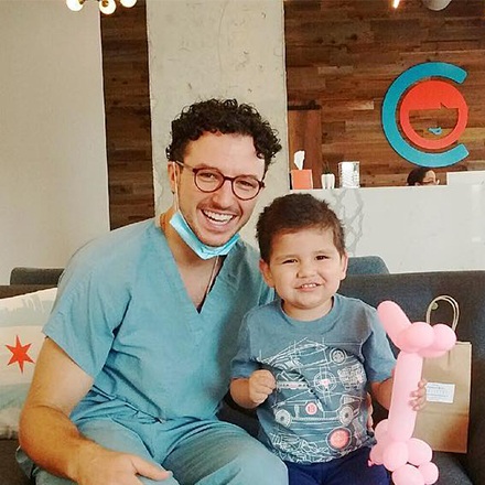 Dr. Justin smiling with young patient