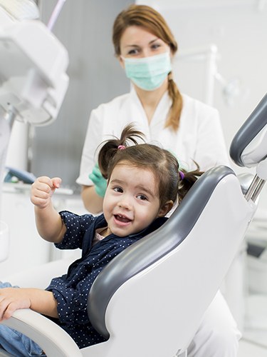 Smiling young girl in dental chair