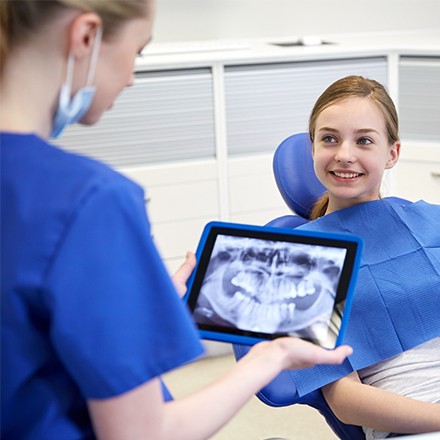 Smiling girl in dental chair