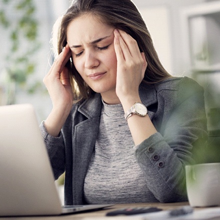 woman with headache who needs Botox