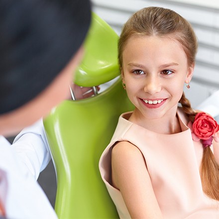 Smiling young girl in dental chair