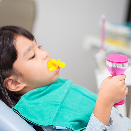 Child receiving silver diamine fluoride treatment