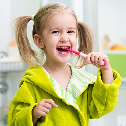 Little girl brushing her teeth