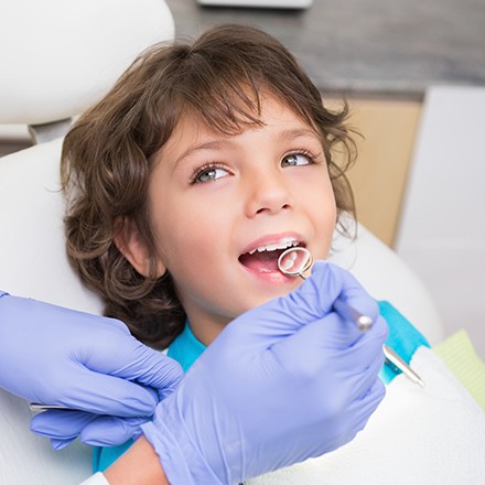 Child receiving dental treatment