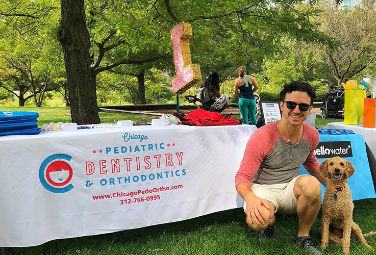 Dr. Justin and a dog at community event