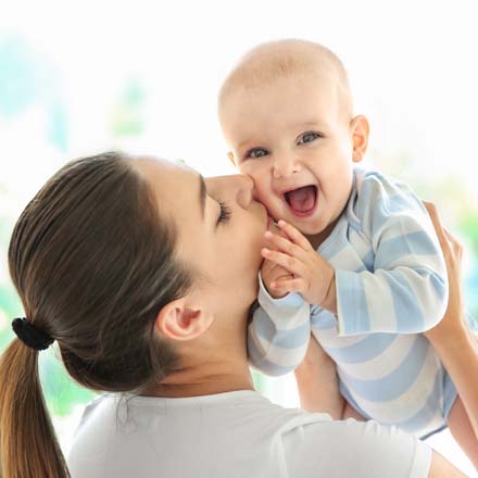 mom kissing young child