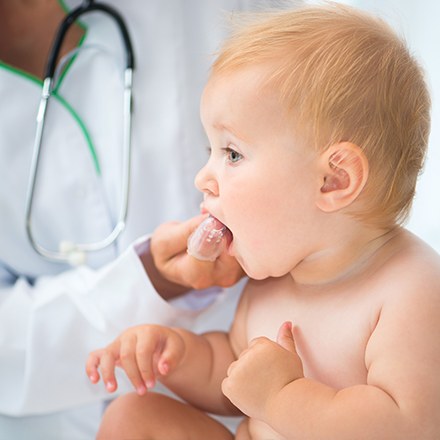 Dentist giving baby fluoride treatment