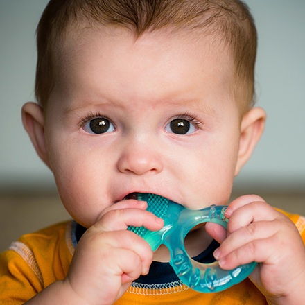 Baby chewing on teething ring