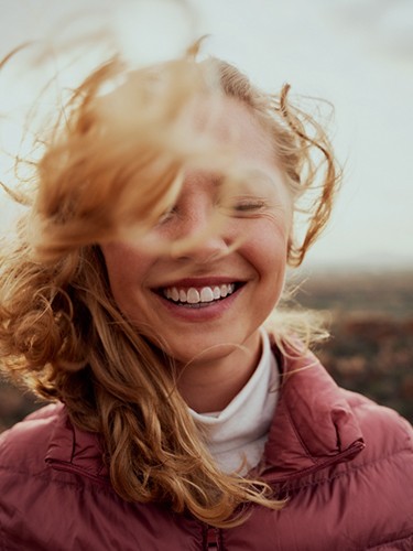 Portrait of smiling, happy woman standing outdoors