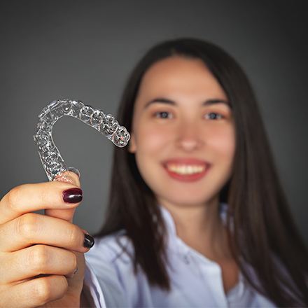 Woman holding up an alignment tray