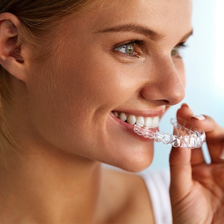 Woman placing aligner tray