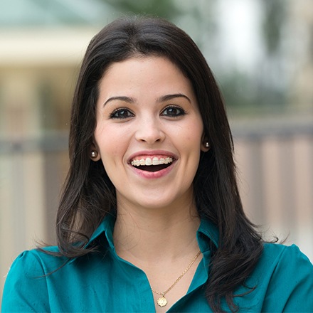 Woman with tooth colored bracket and wire braces