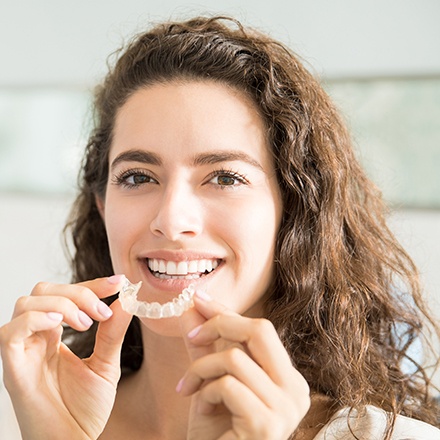 Teen placing Invisalign tray