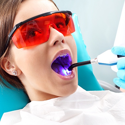 Woman receiving dental sealant treatment