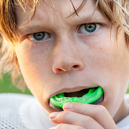 Teen boy placing sportsguard