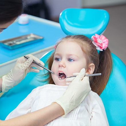 Little girl receiving dental exam