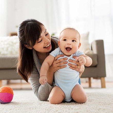 happy baby with mom after infant oral care