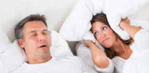 Man snoring in bed