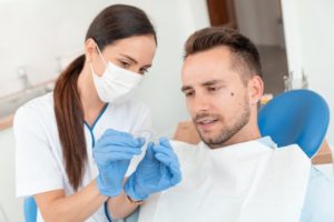 orthodontist holding Invisalign with patient