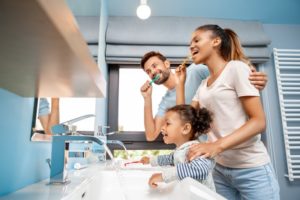 family brushing teeth together for children’s dental health