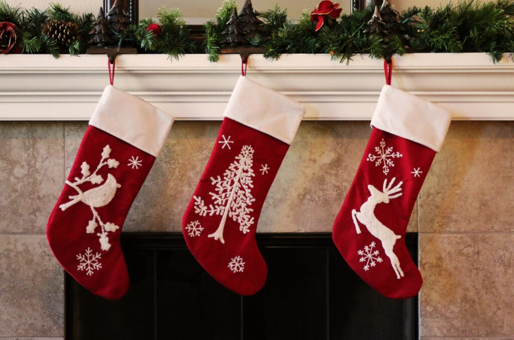 Three decorated red stockings hung on the mantle